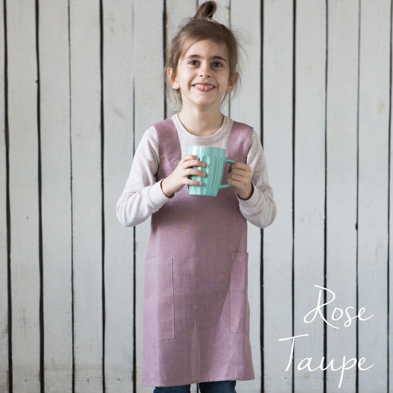 A girl modeling a linen crossover apron, showcasing its comfy and functional design.