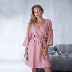 Woman wearing teal linen bathrobe holding mug – handmade robe from soft European flax linen