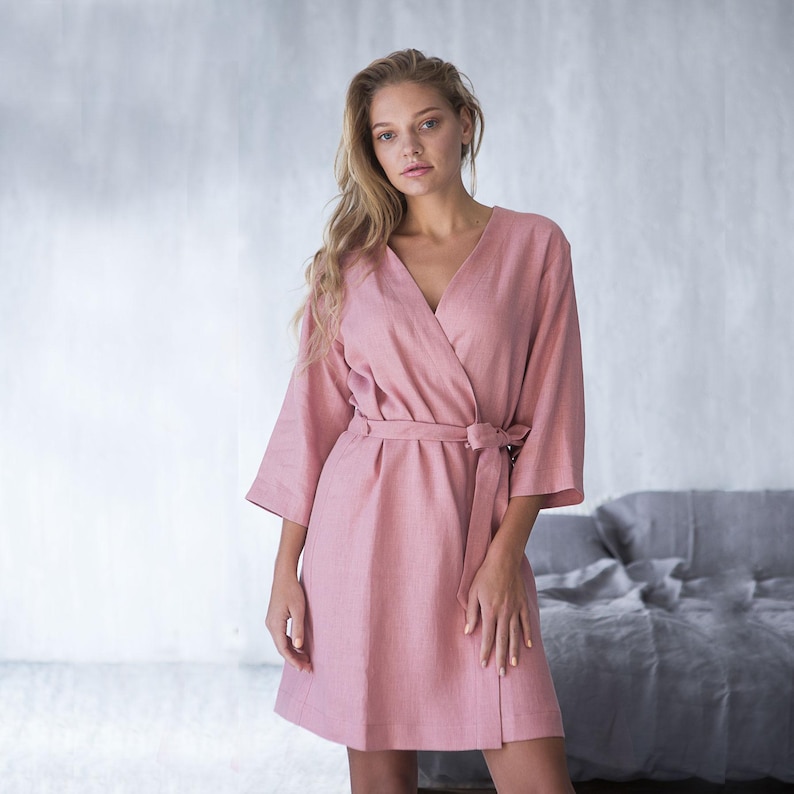 Woman wearing teal linen bathrobe holding mug – handmade robe from soft European flax linen