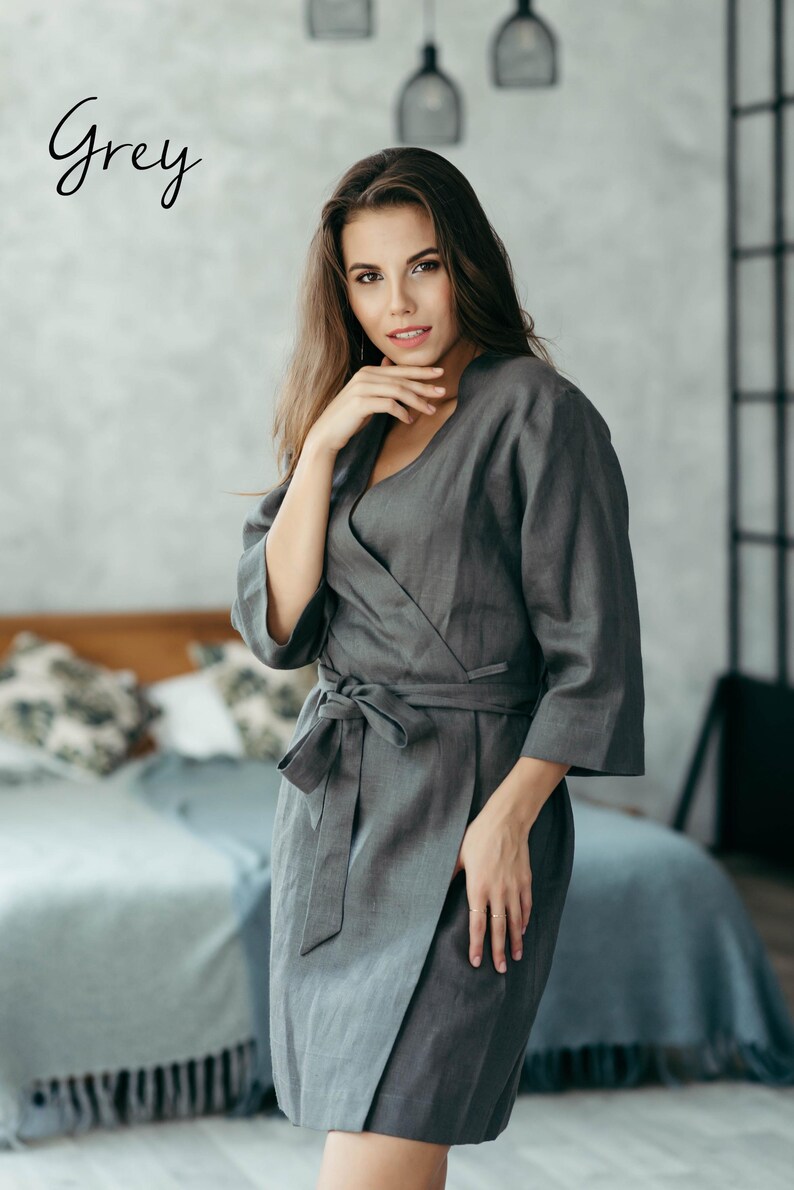 Woman in grey linen kimono-style robe seated indoors – soft natural loungewear