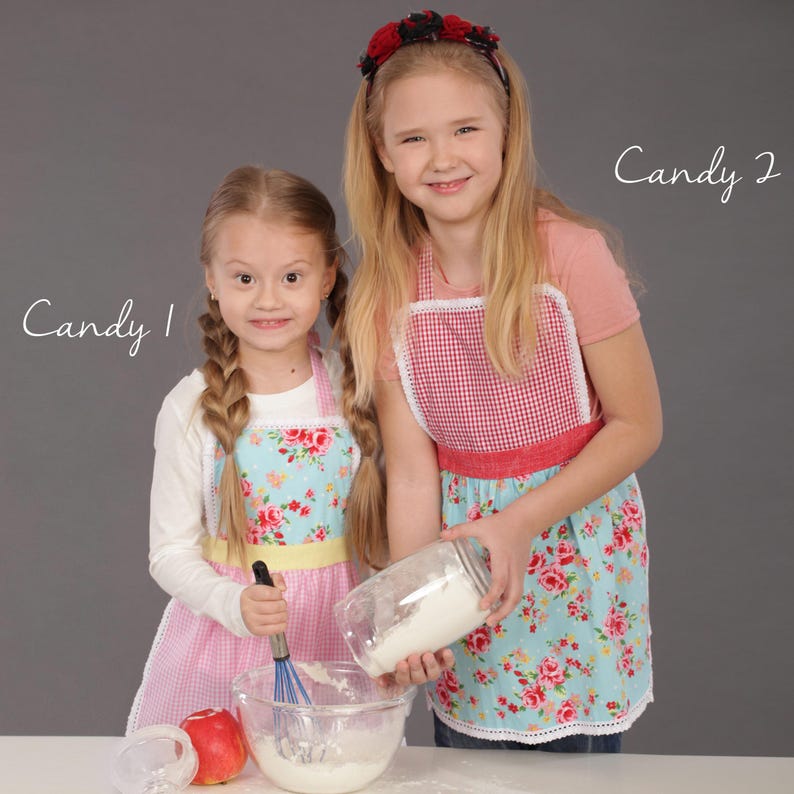 Two sisters wearing matching floral aprons, fun family baking gift idea.