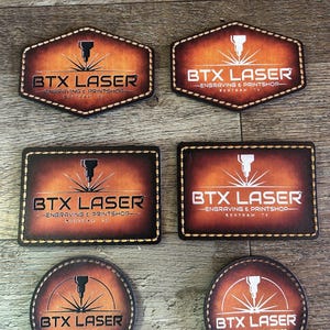 May include: A collection of laser-engraved leather coasters in various shapes: hexagon, rectangle, and circle. Each coaster features the text "BTX LASER - Engraving & Printshop - Bertram TX" and a graphic of a laser cutter.