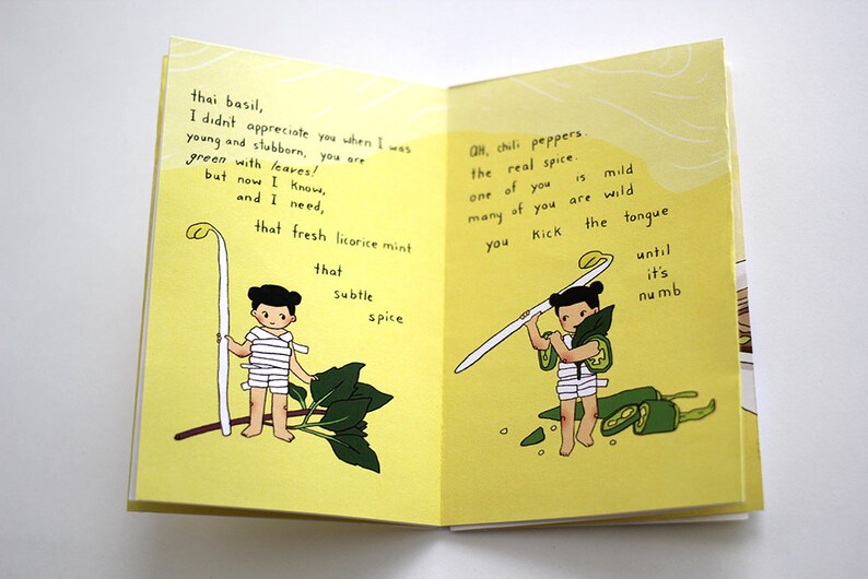 May include: An open book with illustrations and text on yellow pages. One page shows a figure with a plant, the other with chili peppers. Text includes "thai basil" and "chili peppers, the real spice."