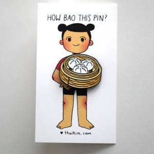 May include: A cartoon character holding a basket of steamed buns with the text "How bao this pin?" and the website "thaikim.com" below.