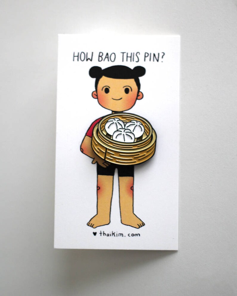 May include: A cartoon character holding a basket of steamed buns with the text "How bao this pin?" and the website "thaikim.com" below.