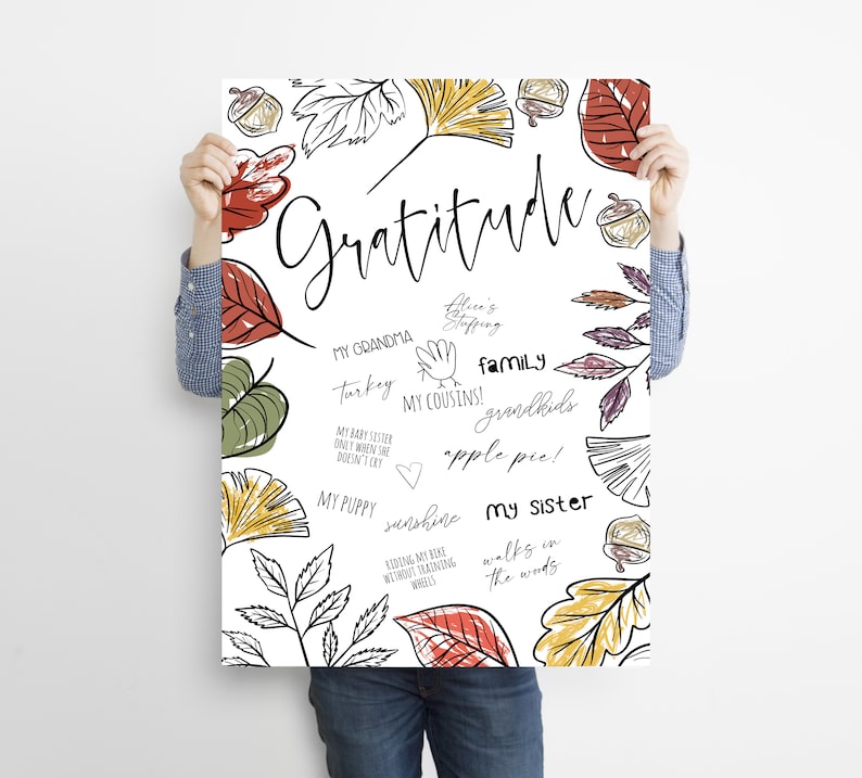 Peut inclure: Une affiche imprimable blanche avec un motif dessin&eacute; &agrave; la main de feuilles d'automne dans des tons de rouge, orange, jaune et vert. L'affiche pr&eacute;sente le mot "Gratitude" en &eacute;criture cursive noire et une liste de choses pour lesquelles &ecirc;tre reconnaissant, notamment "Ma grand-m&egrave;re", "Dinde", "Mes cousins", "Famille", "Petits-enfants", "Tarte aux pommes", "Mon chiot", "Soleil", "Faire du v&eacute;lo sans roulettes", "Ma s&oelig;ur" et "Promenades dans les bois".