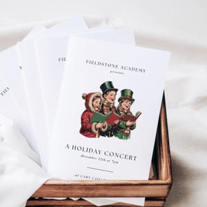 Peut inclure: Une affiche blanche avec le texte "Fieldstone Academy présente Un concert de Noël le 12 décembre à 19h au Cary Concert" et une illustration de trois enfants chantant à partir d'un livre.