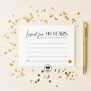 May include: A white card with the text "Loved for 90 YEARS" and lines for writing, with a gold pen and gold confetti. The card also includes the text "SHARE A FAVORITE MEMORY OR WISH" and the word "love."
