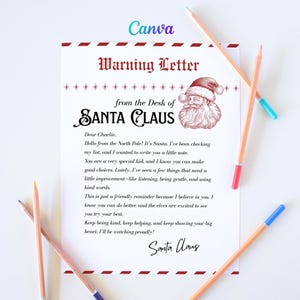 May include: A festive letter from Santa Claus, featuring the text "Warning Letter" and a Santa illustration. The letter is addressed to "Charlie" and offers a friendly reminder. Several pencils with coloured tips are scattered around the letter.