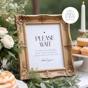 May include: A gold framed sign with the text "PLEASE WAIT" and the message "To enjoy the desserts until after the happy couple has cut the cake. Thank you."