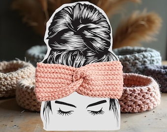 May include: A pink knitted headband with a knotted design. The headband is worn by a woman with a bun in her hair. The headband is made of a soft, comfortable material and is perfect for keeping your hair out of your face.