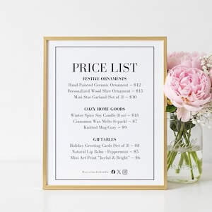 May include: A framed price list with festive ornaments, cozy home goods, and giftables. The list includes items like hand-painted ceramic ornaments, candles, and greeting cards. A bouquet of pink flowers sits to the right.