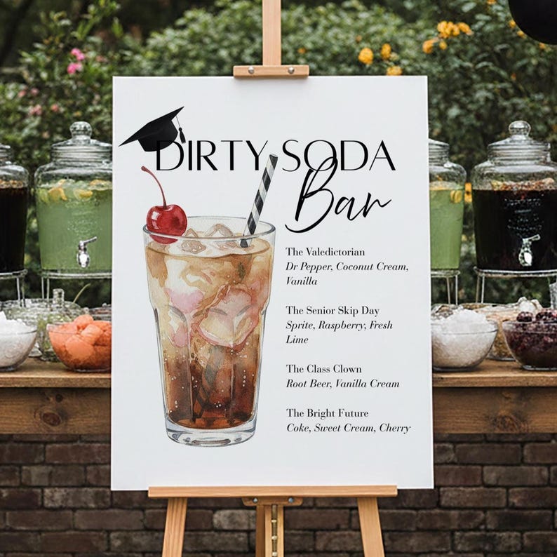 May include: A white sign on an easel with the words "DIRTY SODA Bar" and a graduation cap illustration. The sign lists soda drink recipes, including "The Valedictorian" and "The Bright Future." A glass of soda with a cherry and straw is pictured.