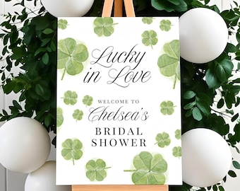 May include: White sign with green shamrocks and the text "Lucky in Love"  "Welcome to Chelsea's Bridal Shower"