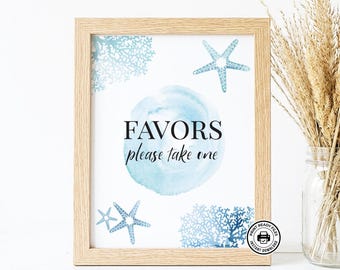 May include: A light wood frame containing a white sign with blue watercolor accents, starfish, and coral illustrations. The text reads "FAVORS please take one" in black lettering. A small circular icon in the corner displays a printer symbol.