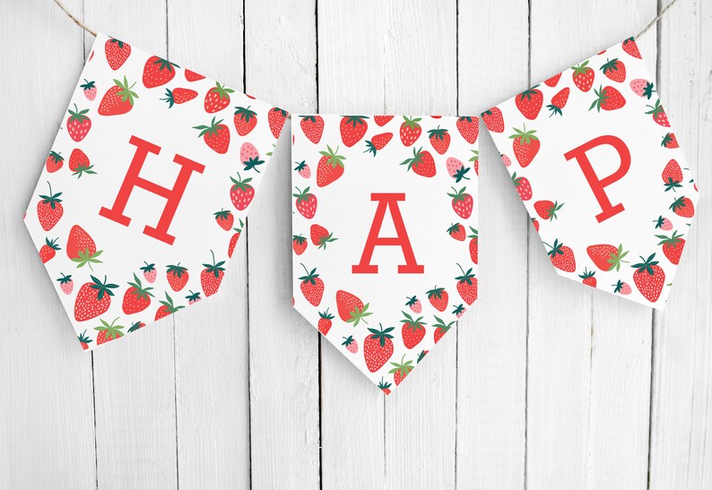 May include: A white banner with red strawberries printed on it. The banner spells out "HAPPY" in red letters.