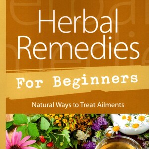 May include: Book cover with the title "Herbal Remedies for Beginners: Natural Ways to Treat Ailments" by Sandra Kynes. The cover features a close-up of a wooden table with a cup of herbal tea, various herbs, and bottles of essential oils.