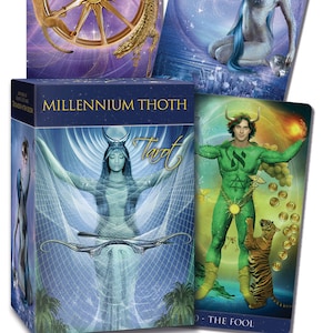 May include: A box of Millennium Thoth Tarot cards with a blue background and gold lettering. The box features an image of a woman in a blue and white dress holding a bow and arrow. The text "Millennium Thoth Tarot" is printed on the front of the box.