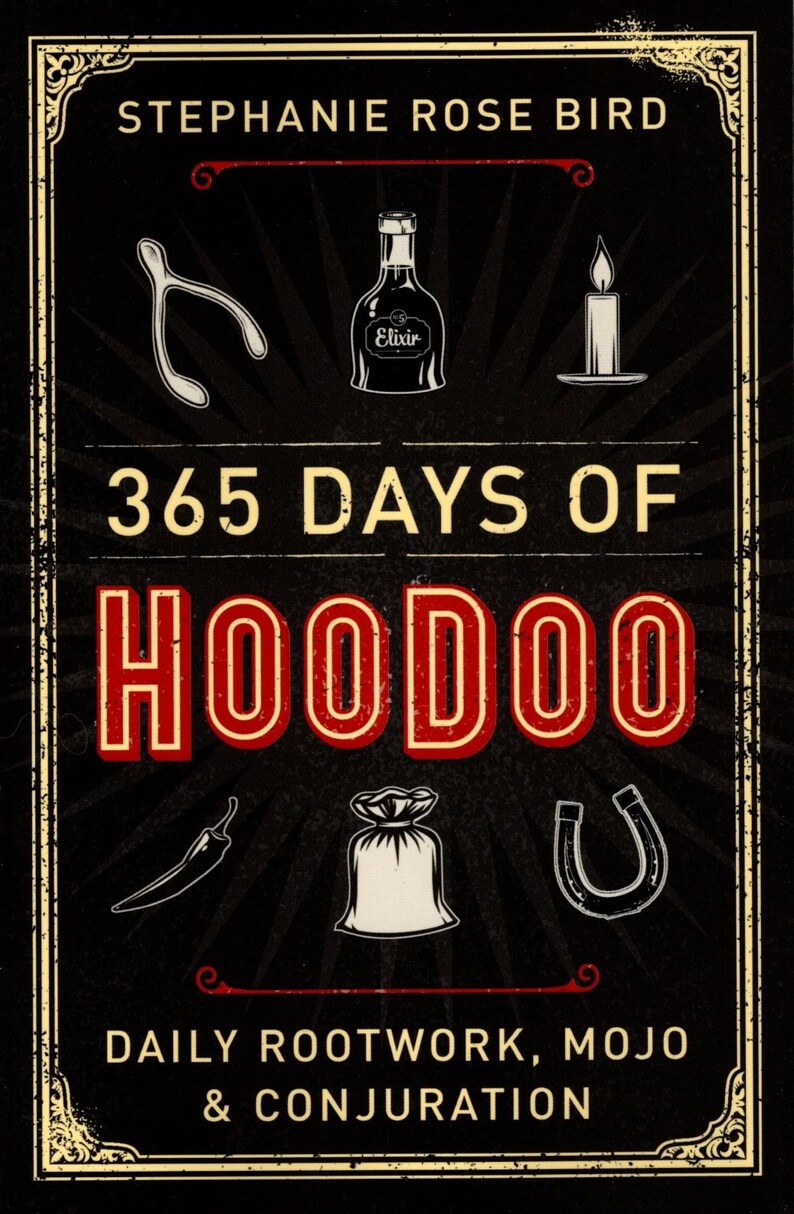 May include: A book cover with a black background and gold trim. The title is "365 Days of Hoodoo: Daily Rootwork, Mojo & Conjuration" in white text. The author's name, "Stephanie Rose Bird", is at the top in white text. There are several illustrations of hoodoo symbols, including a horseshoe, a bag of herbs, a hot pepper, a wishbone, a bottle of elixir, and a candle.