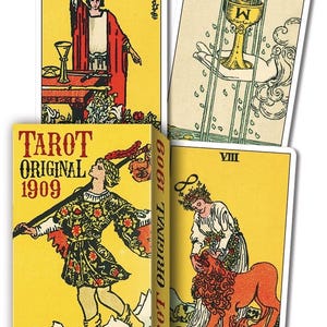May include: A Tarot deck with four cards visible, including the box. The cards have illustrations on yellow backgrounds with figures and symbols. The box reads "TAROT ORIGINAL 1909" with the authors' names. The cards have Roman numerals and the word "STRENGTH."