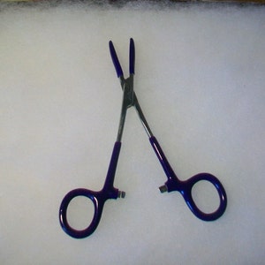 May include: A pair of blue-handled surgical forceps with a silver metal body.