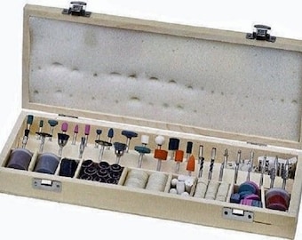 May include: A wooden box filled with a variety of rotary tool bits, including sanding drums, grinding stones, and cutting bits. The box is organized with rows of different types of bits.