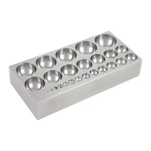 May include: A metal tool with a rectangular base and multiple round depressions of varying sizes. The tool is used for shaping metal.