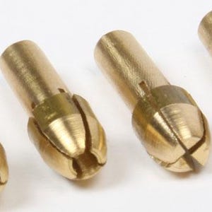 May include: Four brass collet chucks, ideal for holding small drill bits or other tools. Each chuck has a cylindrical body and a slotted, tapered end for gripping. The brass has a shiny, metallic finish.