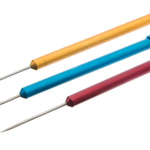 May include: Three metal tools with long, thin needles. The tools are gold, blue, and red.