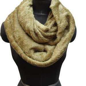 May include: A brown faux fur infinity scarf. The scarf is soft and fluffy and would be a great addition to any winter wardrobe.