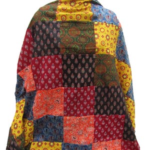 May include: A patchwork jacket featuring a vibrant mix of colors and patterns. The jacket is composed of various fabric squares in red, black, yellow, and blue, each with unique floral and paisley designs. The jacket's design is visible from the back.