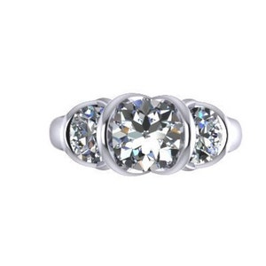 May include: A silver three-stone engagement ring with round cut diamonds.