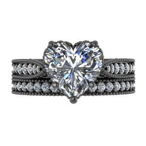 May include: A black diamond heart-shaped engagement ring with a black band and a row of small diamonds on each side.