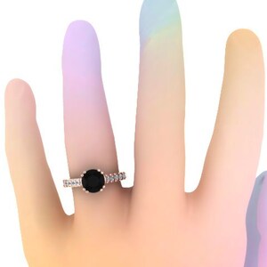 May include: A rose gold engagement ring with a black diamond center stone and a band of smaller diamonds.