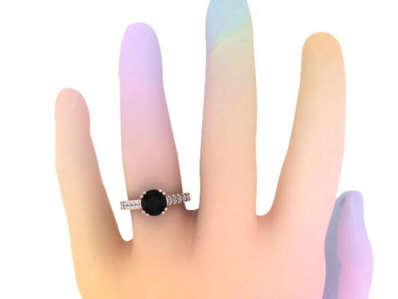May include: A rose gold engagement ring with a black diamond center stone and a band of smaller diamonds.