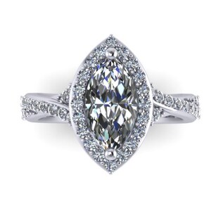 May include: A silver engagement ring with a marquise-shaped diamond center stone surrounded by a halo of smaller diamonds. The band is twisted and features additional diamonds.