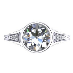 May include: A silver ring with a large round clear gemstone surrounded by smaller clear gemstones on the band.