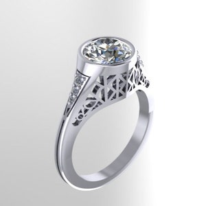 May include: A silver ring with a large, round, clear gemstone set in a filigree design. The ring has a delicate, intricate design and is a beautiful piece of jewelry.