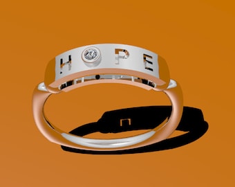 May include: A silver ring with the word "HOPE" cut out and a small diamond set in the center of the band.