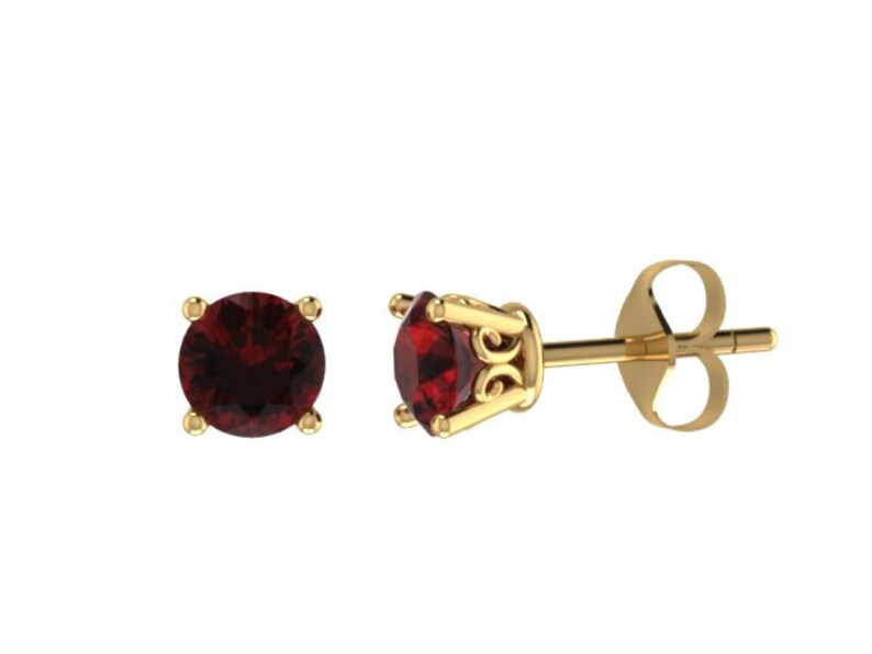 May include: A pair of gold stud earrings with a red gemstone in the center of each earring.