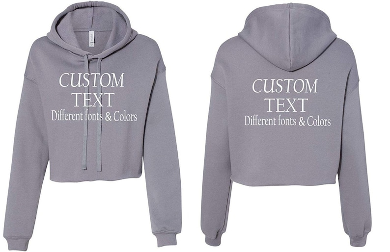 May include: A gray cropped hoodie with a drawstring hood. The hoodie has "CUSTOM TEXT" written on the front and back in white text. The text below says "Different fonts & Colors".