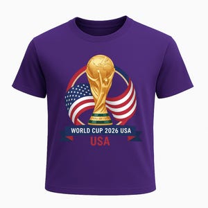 May include: A purple t-shirt featuring a gold trophy graphic with the text "WORLD CUP 2026 USA". The graphic includes the American flag and a ribbon with the word "USA".