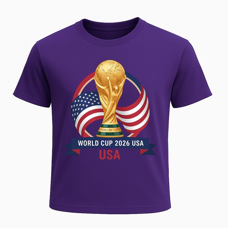 May include: A purple t-shirt featuring a gold trophy graphic with the text "WORLD CUP 2026 USA". The graphic includes the American flag and a ribbon with the word "USA".