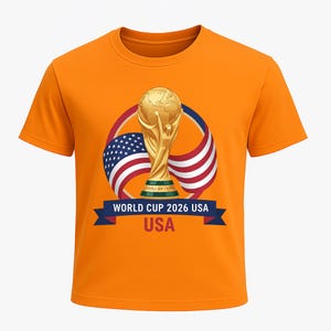 May include: Orange t-shirt featuring a gold trophy, the American flag, and the text "WORLD CUP 2026 USA." The design includes a blue banner with white text. The shirt is a short-sleeved crew neck.