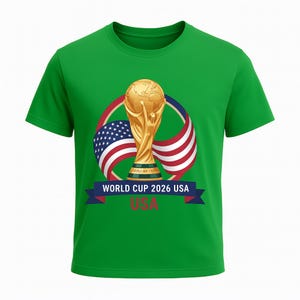 May include: Green t-shirt featuring a gold trophy, the USA flag, and text that reads "WORLD CUP 2026 USA". The design includes a blue banner with white text and a red, white, and blue design.