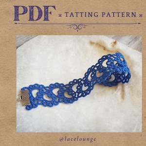 May include: A blue tatting pattern with a detailed lace design. The image includes the text "PDF * TATTTING PATTERN" and the @lacelounge watermark. The lace is a vibrant blue colour, with a silver clasp.