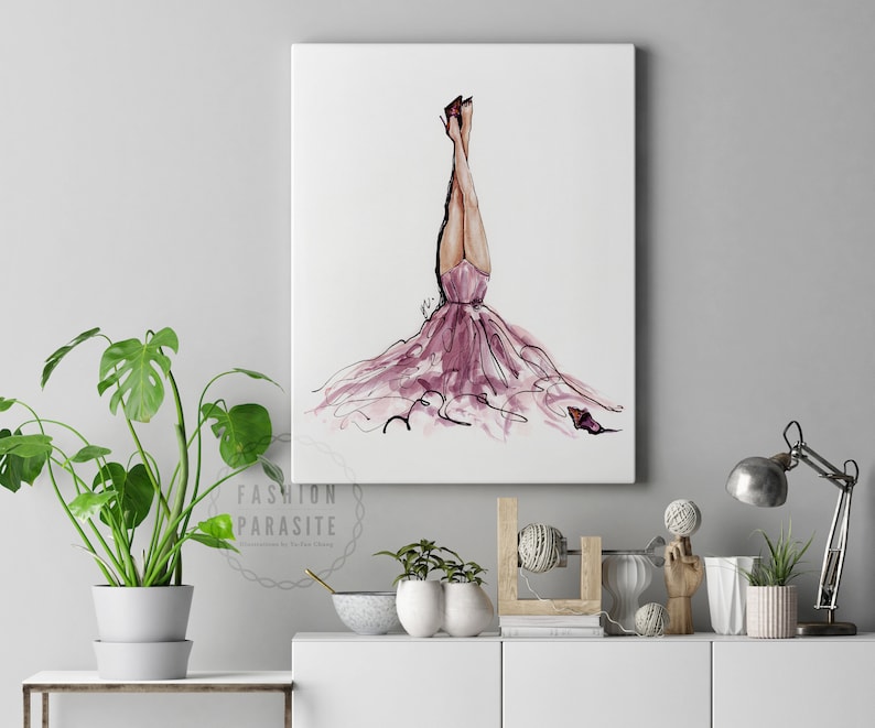 May include: A watercolour painting of a woman in a pink dress with her legs in the air. The dress is flowing and the woman's hair is long and flowing. The painting is on a white background.