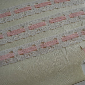 May include: White lace trim with pink stripes. The trim is shown on a white background with the text "36 Yds."