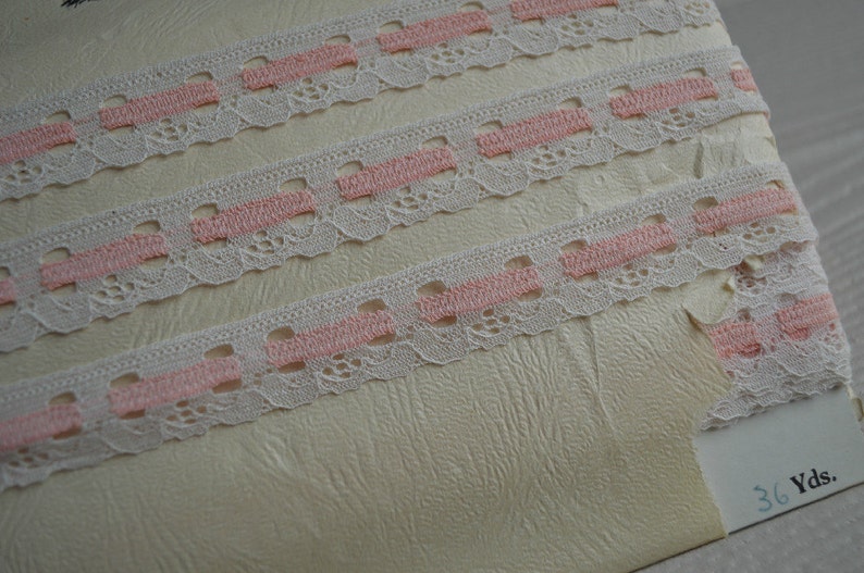 May include: White lace trim with pink stripes. The trim is shown on a white background with the text "36 Yds."