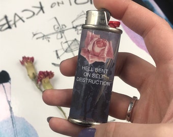 Reusable lighter case with The Front Bottoms lyrics and Rene Magritte design